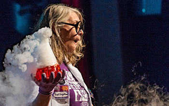 Mad scientist holding a beaker with red liquid in it and smoke pouring out