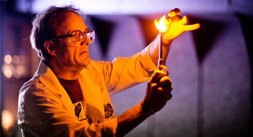 Mad scientist using a lighter to light what's in his hand