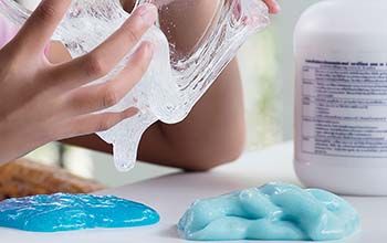 Female hands playing with clear slime